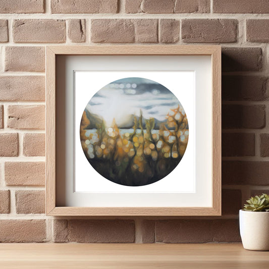 Wanaka lakefront, fine art print in a blurry bokeh style. Autumn light on Lake Wanaka, New Zealand. Painted by New Zealand artist Mel McKenzie. Orange and rust tones. Round art on a square print framed in a wooden frame and hanging on a brick wall.
