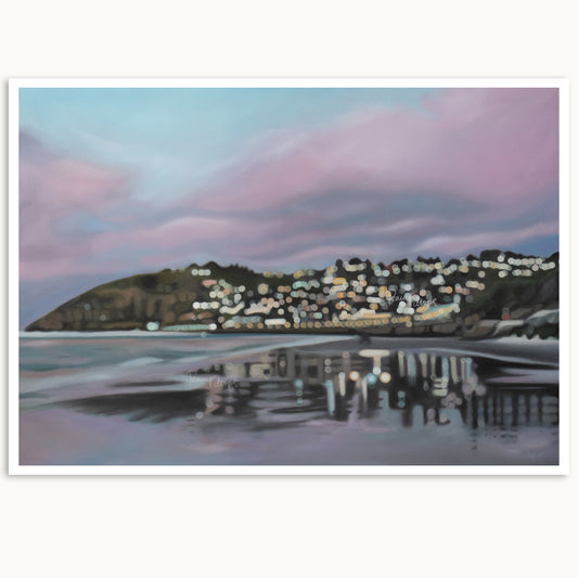 Cityscape at sunrise reflected in water with pink and blue sky. Featuring St Clair Beach, Dunedin, New Zealand. By Mel McKenzie, NZ artist of The Penny Drops.