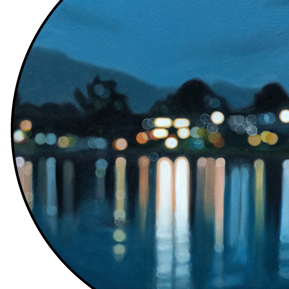 Blue painting of Lake Te Anau by New Zealand artist Mel McKenzie in a blurry bokeh style. Round oil painting on canvas framed in black shows lakeside lights reflected on water.