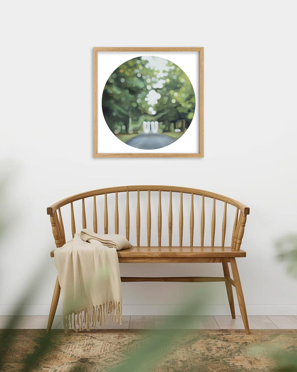 Lush green bokeh art print hangs above a wooden bench seat in a square wooden frame. The image features Invercargill's Queens Park.