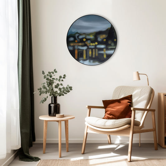Wanaka, New Zealand, lakefront water reflections, art hanging in living room.. Painting on round canvas framed in black circular frame. Painted in oils in a blurry bokeh style by New Zealand artist Mel McKenzie, The Penny Drops.